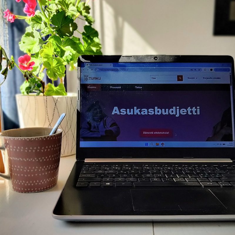 kannettava tietokone pöydällä. koneen näytöllä näkyy teksti "asukasbudjetti"